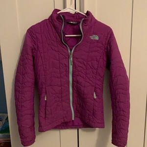 A plum purple North Face jacket.